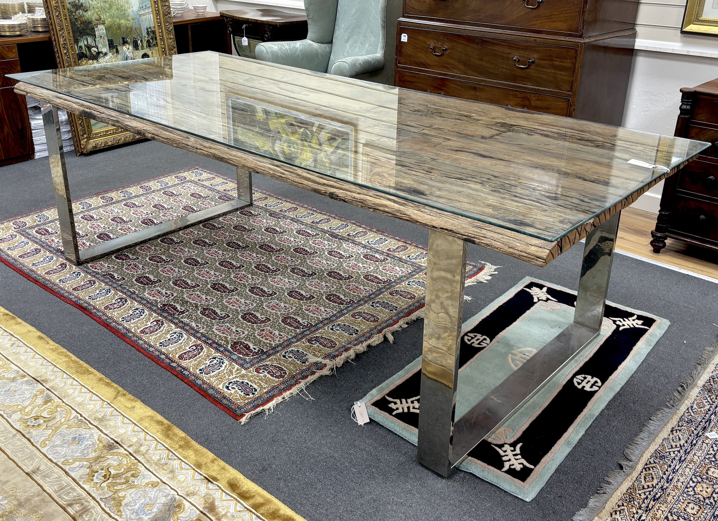 A rustic rectangular driftwood dining table, on a stainless steel base with plate glass top, length 240cm, width 100cm, height 77cm